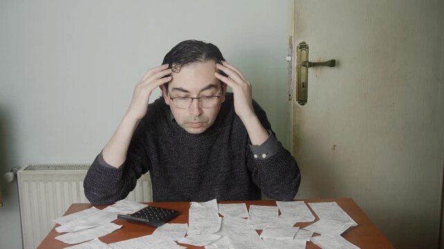 Frustrated Caucasian Man Managing Household Finance and Calculating Expenses