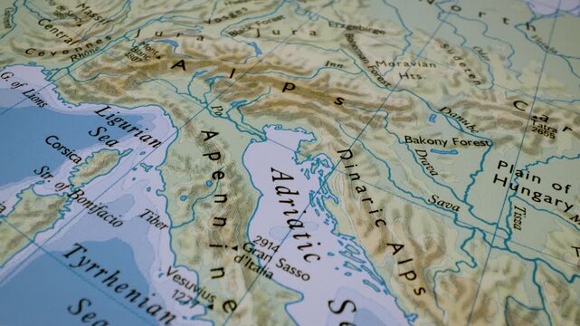 close up gliding shot from the apennines to the alps on a relief map