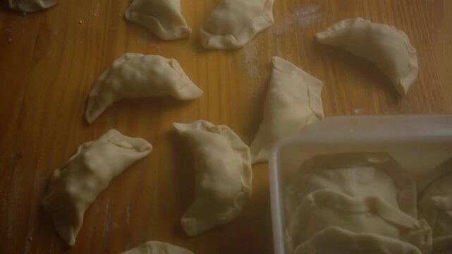 High Angle Tilting and Panning Shot of Raw Homemade Empanadas on Table