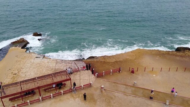 Aerial view of tourists at coastal viewpoint in paracas, peru
