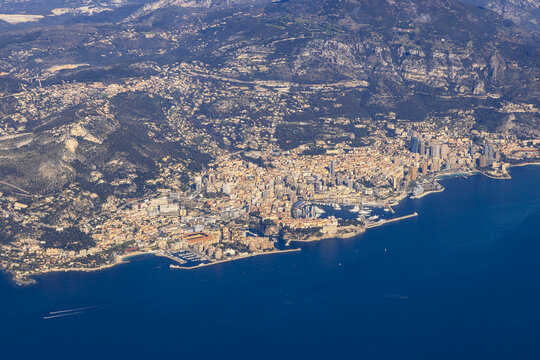 Aerial view of the French Riviera coastline featuring the city of Monaco, Monte Carlo with its dense urban architecture, harbor, and Mediterranean sea, Nice, Provence-Alpes-Cote d'Azur, France.