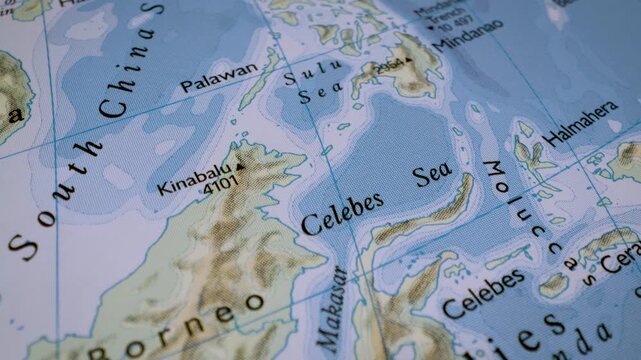 close up gliding shot toward borneo on a detailed relief map