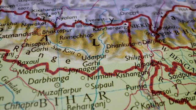 gliding macro view from india and nepal to mount everest on a physical atlas map