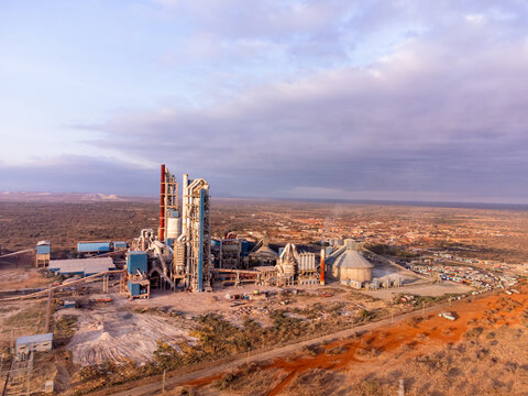 Aerial view of the Simba Cement Merueshi plant featuring industrial silos, processing towers, and conveyor systems set against the arid landscape of Kajiado, Kajiado County, Kenya.