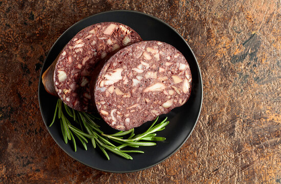 Blood sausage with meat offal accompanied by rosemary.