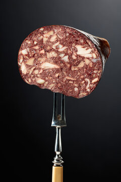 Black pudding or blood sausage on a fork.