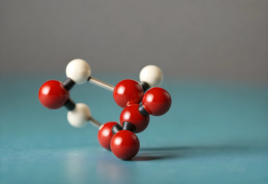 Molecular model with red and white spheres connected by rods, chemical structure and scientific research