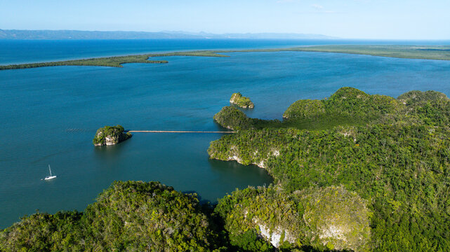 Aerial view of Los Haitises National Park with limestone karst islands, dense mangrove forests, and a boat in Samana Bay, Municipio de Sabana de la Mar, Hato Mayor Province, Dominican Republic.