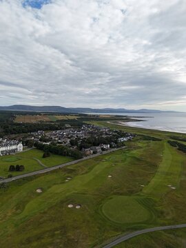 Dornoch is a beautiful Highland town facing the sea, where sunset paints the coast golden, highlighting sandy shores, historic buildings, and landscapes.