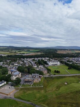 Dornoch is a picturesque Highland town in northern Scotland, featuring a 1224 cathedral, 1509 castle, historic streets, green hills, and changing skies.