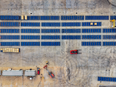 Aerial view of the Brendale BESS facility featuring rows of blue battery storage containers, industrial equipment, and tire marks on the concrete ground in Brendale, Queensland, Australia.