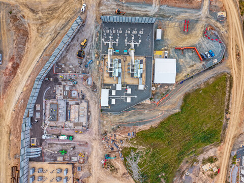 Aerial view of the Brendale BESS construction site featuring power infrastructure, heavy machinery, and site development in Brendale, Queensland, Australia.