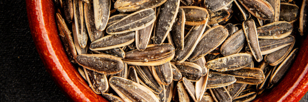 Salted sunflower seeds tasty snack fresh and delicious gourmet food background on the table rustic food top view copy space