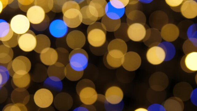 Christmas Bokeh lights no action observed, in indoor or outdoor scene with artificial lighting, with bokeh lights, from a static camera capturing the scene perspective, with yellow, blue accents.