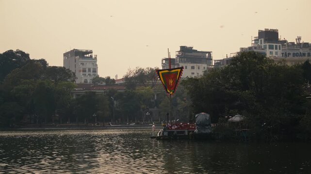 Hoan Kiem lake in Ha Noi, Vietnam with dragonflies flying