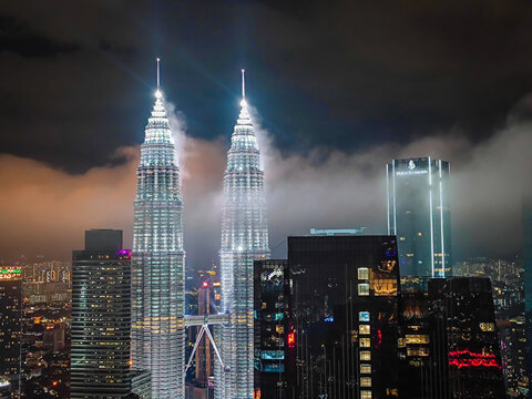 08 02 2026 - Kuala Lumpur, Malaysia. Petronas Twin Towers. Aerial drone night panorama of Kuala Lumpur, Malaysia, illuminated iconic skyscrapers with dramatic lightning in the stormy background