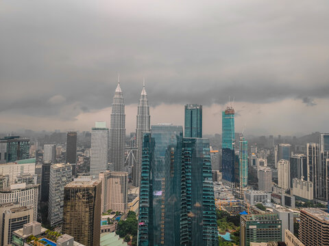 08 02 2026 - Kuala Lumpur, Malaysia. Aerial drone night panorama of Kuala Lumpur, Malaysia, illuminated Petronas Twin Towers and iconic skyscrapers with dramatic lightning in the stormy background