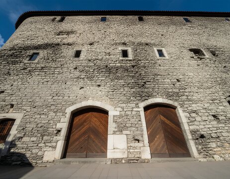 Ancient stone archways with weathered brick and metal gates.