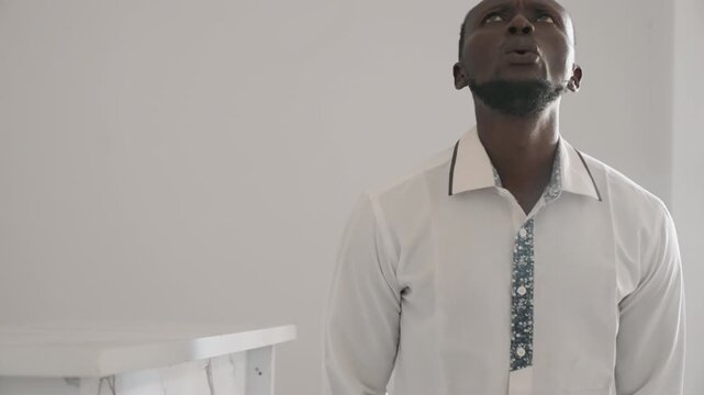 Taking deep breaths to ease nervousness. Person practicing calmness before important social engagement. Man reducing anxiety through deep breathing exercises ahead of scheduled encounter