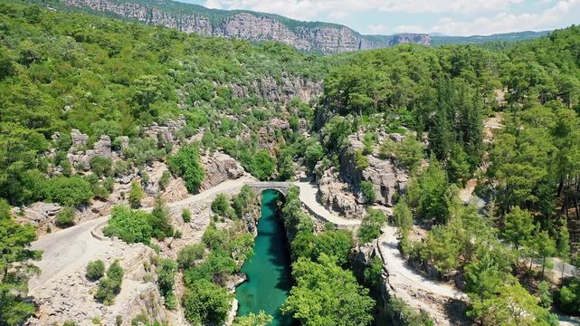 Aerial view of Koprulu Canyon in Manavgat, Antalya, showcasing the dramatic river gorge and lush green forest landscape. Majestic drone shot over Turkey's famous national park.