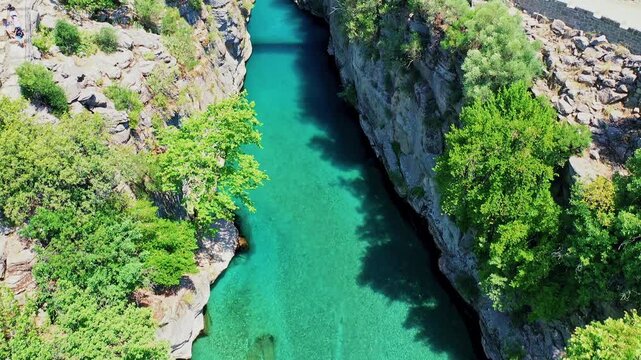 Aerial view of the historic stone bridge at Koprulu Canyon in Antalya, showcasing the ancient architecture over the deep river valley. Majestic drone flight in Manavgat, Turkey.