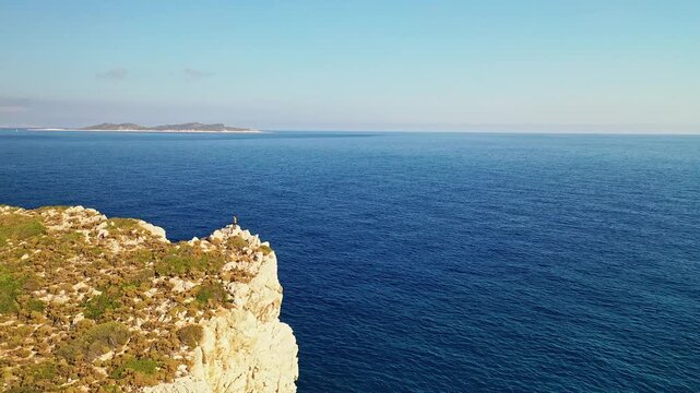 Man exploring rocky hills near Patara Beach in an aerial drone view. Scenic Mediterranean landscape in Antalya, Turkey.