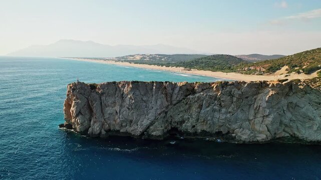 Man exploring rocky hills near Patara Beach in an aerial drone view. Scenic Mediterranean landscape in Antalya, Turkey.