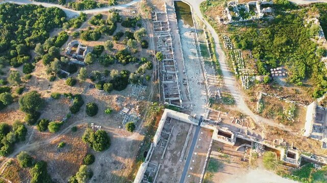 Patara ancient theater and parliament building aerial view highlighting iconic Lycian archaeological ruins in Antalya, Turkey. Dramatic drone shot over history.