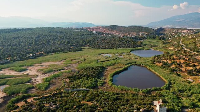 Patara ancient city in Antalya aerial view showcasing historic Lycian ruins and ancient parliament building in Turkey. Majestic drone shot over stone structures.