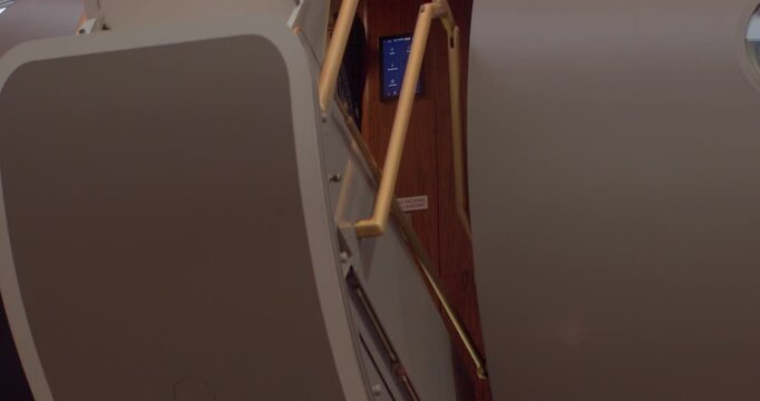 Exclusive airplane access door showcasing sophisticated interior design details. Upscale private jet entrance highlighting refined craftsmanship and modern technological amenities