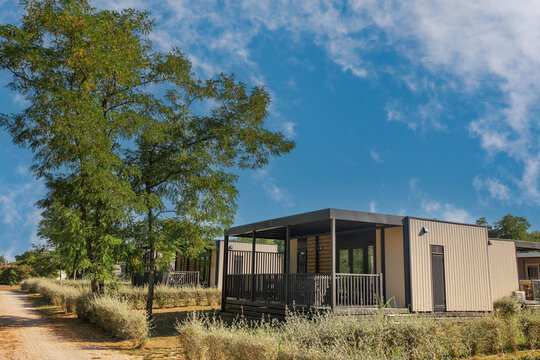 Modern mobile homes with covered porches at resort in Croatia.