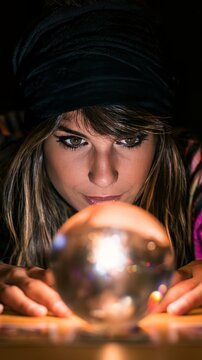 Fortune teller looking into crystal ball predicting future