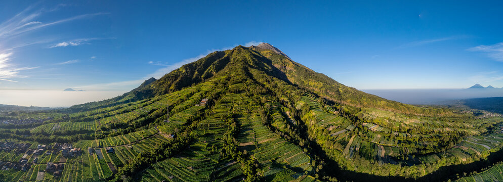 Aerial view of NewSelo with lush green terraced agricultural fields on the slopes of Mount Merapi in Kecamatan Selo, Jawa Tengah, Indonesia.