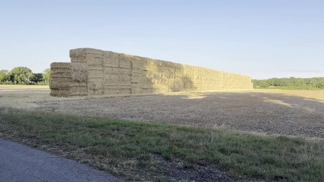 Huge hay bale stack in field 4K