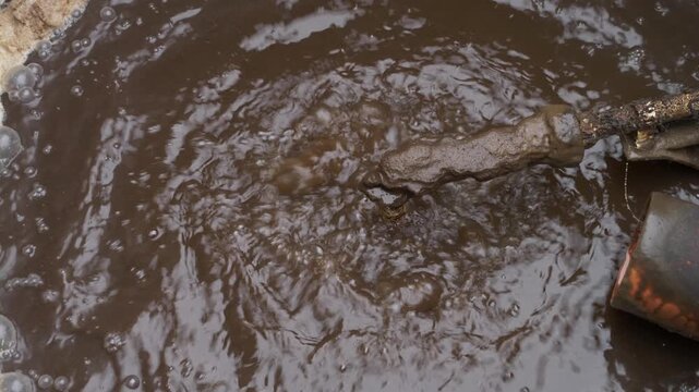 Dirty water and sludge mixing inside wastewater tank