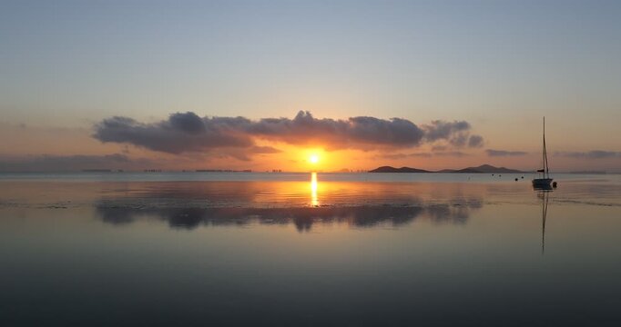 View of the Mar Menor at dawn with two boats on its waters, Punta Prima, Cartagena, Region of Murcia, Spain