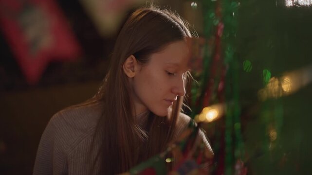 Woman making ribbon cards today. Young woman designs intricate ribbon cards in peaceful environment. Caucasian woman meticulously creates ribbon cards amidst nature and warm lighting conditions