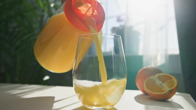 On a vibrant summer afternoon, a delightful cocktail is being crafted in a sunlit kitchen filled with fresh fruits