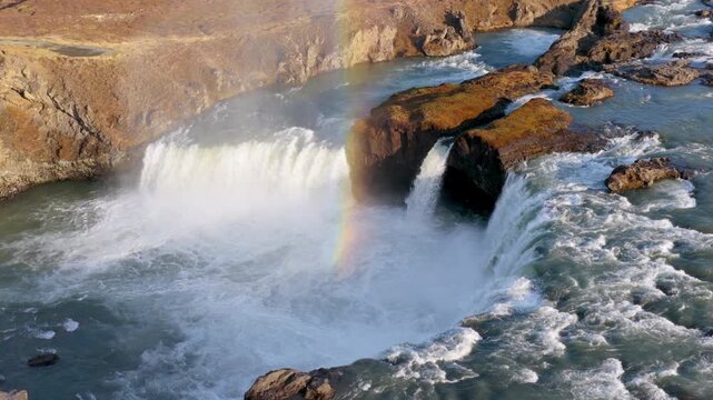Aerial view of Powerful waterfall Godafoss pouring into a rocky basin. Iceland