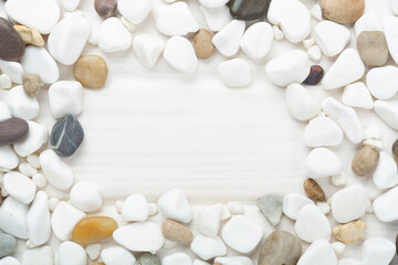 White pebble stones on wooden background, top view © Liami