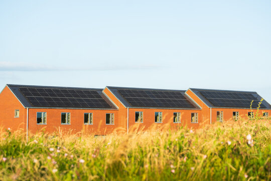 Residential Buildings with Rooftop Solar Panels Concept of Renewable Energy, Sustainable Housing and Green Electricity