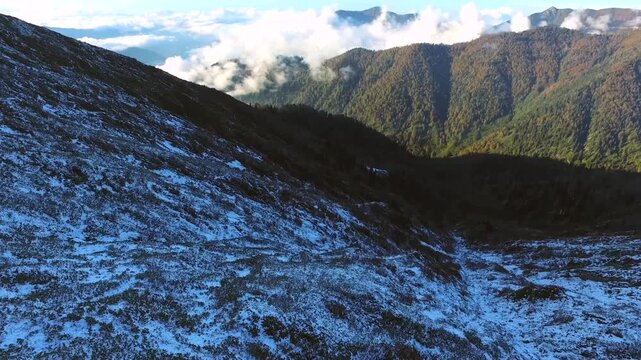 Aerial view of fresh snow covering a sharp mountain ridge in the Peruvian Andes at high altitude.