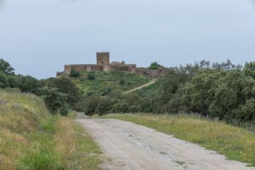 Alentejo landscape with noudar castle and dirt road © ANTONIO COSTA