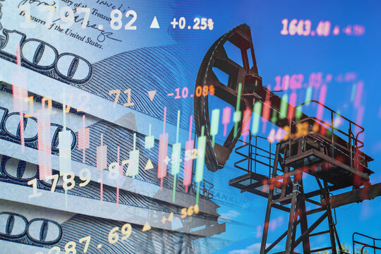 Oil pump jack double exposure with stock market trading data and hundred dollar banknotes on blue sky background, energy finance concept