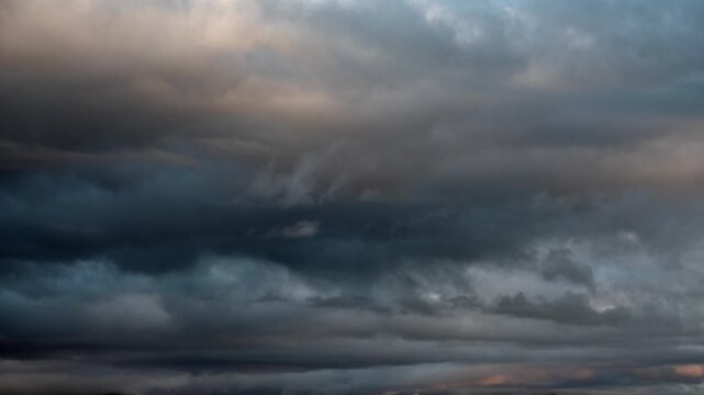 Timelapse of variable dark storm clouds moving across the sky before rainfall with changing weather.