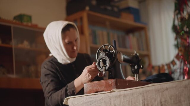 Woman repairing antique sewing machine, focused hands adjust wheel, bookshelf and curtain background, warm lamp glow, careful restoration with tools and thread, concentrated craft atmosphere