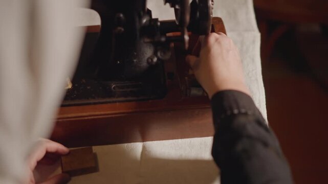 Maintenance expert inspecting and lubricating sewing machine parts carefully. Precise technician in vintage workshop diligently adjusting and cleaning sewing machine components with tools