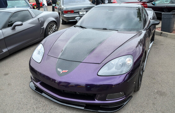 Custom deep purple Chevrolet Corvette C6 coupe showcasing modern American supercar performance, muscular aerodynamic design, and its iconic legacy in automotive culture