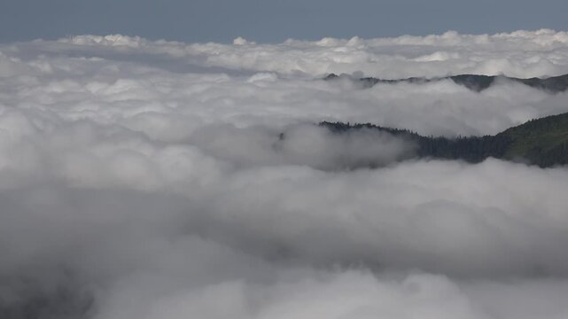 Time lapse aerial view shows clouds moving above tropical Bolivian terrain in wet conditions.