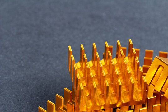 Golden metallic fins stand sharp against a dark surface